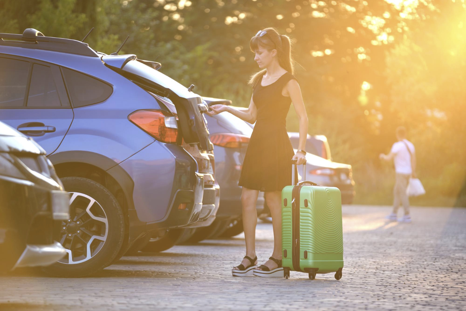 young-female-driver-putting-luggage-suitcase-bag-inside-her-car-travelling-and-vacations-concept